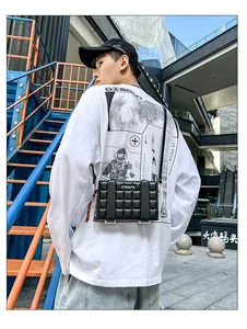 Men's black quilted crossbody box bag with silver metal tag and adjustable strap