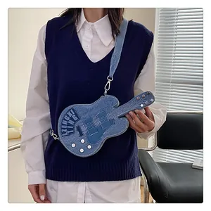 Detail of guitar-shaped denim crossbody bag with creative patchwork and metal hardware