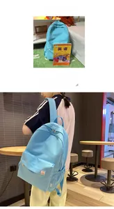 Detail of light blue school backpack featuring side water bottle pocket and brand label