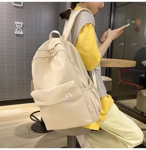 Detail view of cream white corduroy backpack with large front flap and side pockets