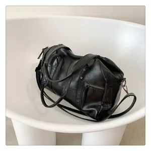 Macro detail of black glossy tote bag with silver metal hooks and premium stitching