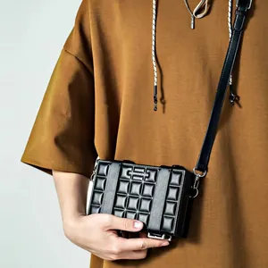 Unisex black checkered box crossbody bag with silver logo plaque and adjustable strap
