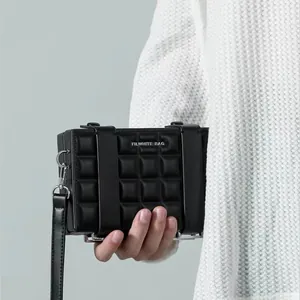Black rectangular crossbody box bag with quilted lattice texture and silver hardware