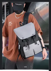 Detail of nylon laptop backpack with night reflection safety feature and dual front pockets