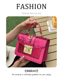 Detail of glittery pink leather shoulder bag with gold square buckle and chain strap