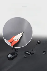 Close-up of waterproof and scratch-resistant grey nylon fabric with water droplets