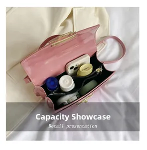 Capacity display of the pink patent leather crossbody bag showing interior compartments