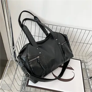 Fashionable black faux leather Boston bag in a metal basket for an urban stylish look