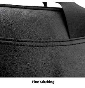 Close-up of fine stitching and lychee grain texture on black leather laptop backpack