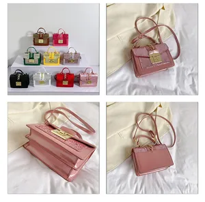 Detail of mini sequin crossbody bag with metal chain lock and diverse color options
