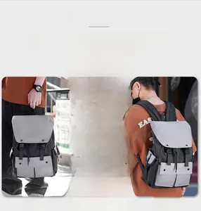 Detailed view of large nylon backpack showing hand-carry, single and double shoulder carry styles