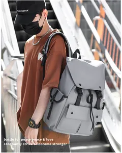 Close-up of durable gray nylon backpack featuring dual buckle flap pockets and large capacity