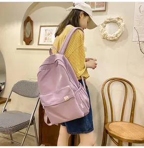 Detail of light purple backpack with cute bear patch and side pocket for school use