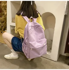 Detail of purple canvas backpack with zipper compartment and side water bottle pocket