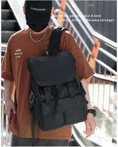 Outdoor shot of a black functional nylon backpack with buckle closures and multiple pockets