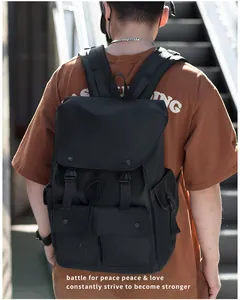 Detail of black nylon tactical backpack with flap closure and buckle straps in urban setting