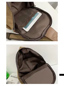 Internal view of the brown canvas chest bag showing the tablet compartment and zipper pocket