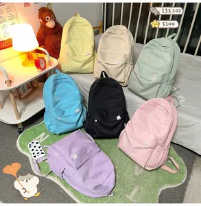 Detailed arrangement of multi-color minimalist canvas backpacks in a cozy home setting