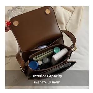 Internal capacity of brown vintage saddle bag showing pockets and storage space