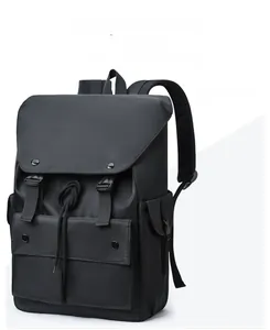 Detail of waterproof nylon backpack featuring drawstring closure and buckled pockets in black