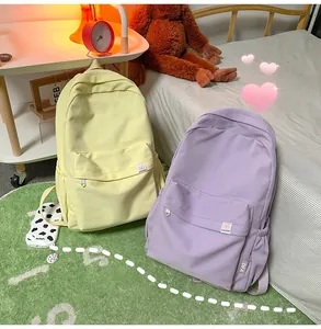 Detail view of colorful minimalist student backpacks in light yellow and purple colors