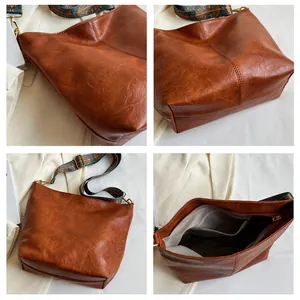 Detail view of brown PU leather tote bag with ethnic jacquard strap and internal pockets