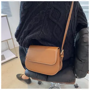 Close-up of the vintage brown PU leather saddle bag with an adjustable shoulder strap