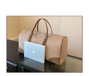 Large khaki canvas weekend bag with leather handles and laptop size comparison