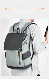 Detail of casual backpack with USB charging port shown while connected to a mobile phone