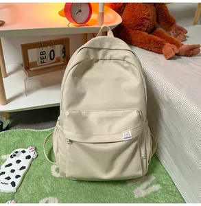 Detail of off-white canvas backpack with DIFA'S BEAR logo and front zipper pocket