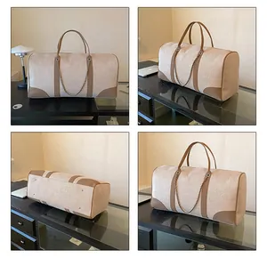 Detail view showing beige canvas travel bag with brown leather trim and metal rivets