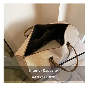 Internal view of large capacity tote bag holding a laptop with an inner zipper pocket