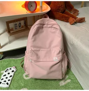 Pink canvas backpack detail with large zipper pocket and cute Difa's Bear logo