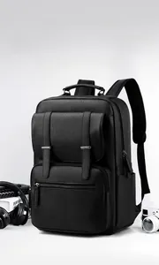 Detailed view of black pebbled leather laptop backpack with premium business accessories