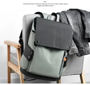 Close-up of canvas backpack with magnetic buckle and flap closure on a gray chair
