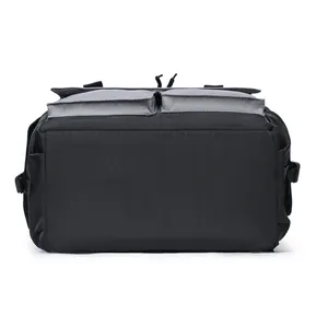 Detail view of durable black nylon backpack featuring two gray front flap pockets