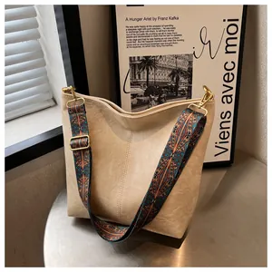 Minimalist beige hobo tote bag with bohemian pattern wide strap and gold hardware