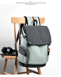 Close-up of business backpack featuring metal snap buttons and water-resistant canvas texture