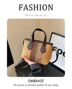 Detail of striped woven tote bag with premium leather handles and adjustable shoulder strap