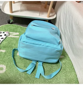 Detailed macro view of sky blue backpack fabric texture with front zipper pocket and tag