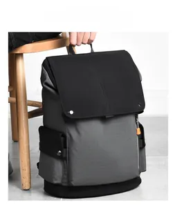 Close-up of casual backpack featuring grey textured fabric and black flap design