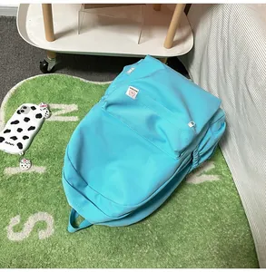 Close-up of a blue backpack with textured fabric, featuring the DifaBear logo label