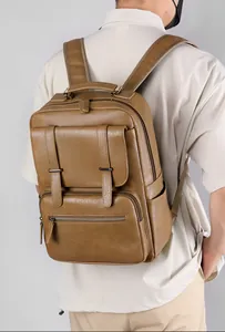 Detailed back view of a vintage brown leather laptop backpack with ergonomic straps