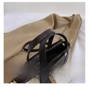 Detailed close-up of premium leather handles and striped woven fabric on the tote bag