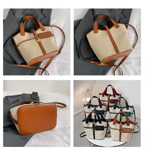 Detailed views of multi-color canvas and leather bucket bags with fashion labels and hardware