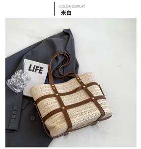 Detailed cream white straw tote bag with brown leather straps and gold rivets