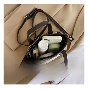 Top view of striped canvas crossbody bag interior showing phone and cosmetics capacity