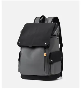 Detail view of the durable dark grey backpack with orange zipper pulls and side pockets