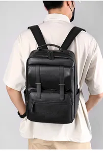 Detail view of black faux leather backpack with pebble texture and buckle pockets