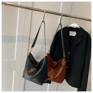 Detail of soft leather hobo bags with decorative geometric woven shoulder straps